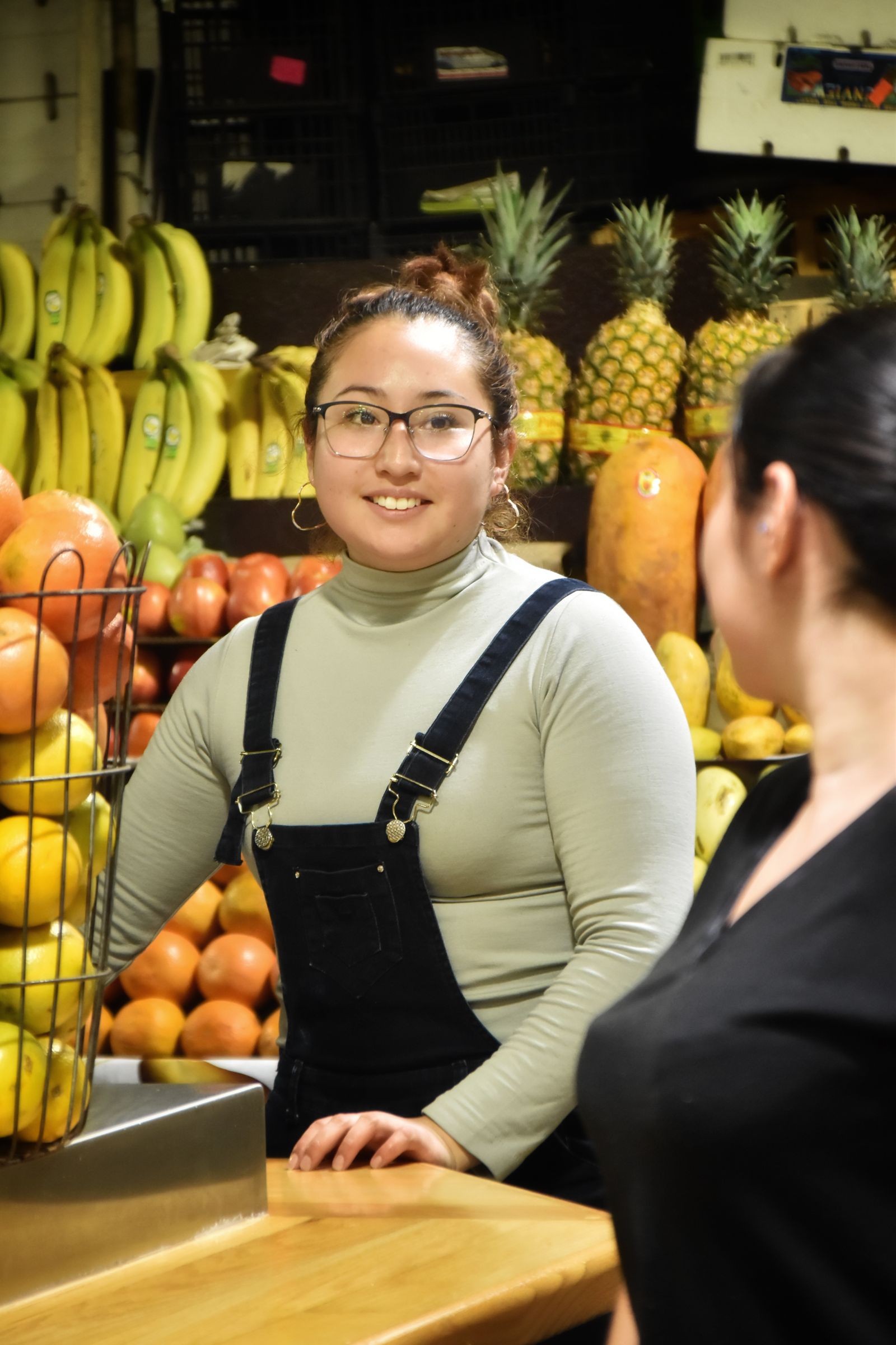 Small business owner smiling at a customer in her shop