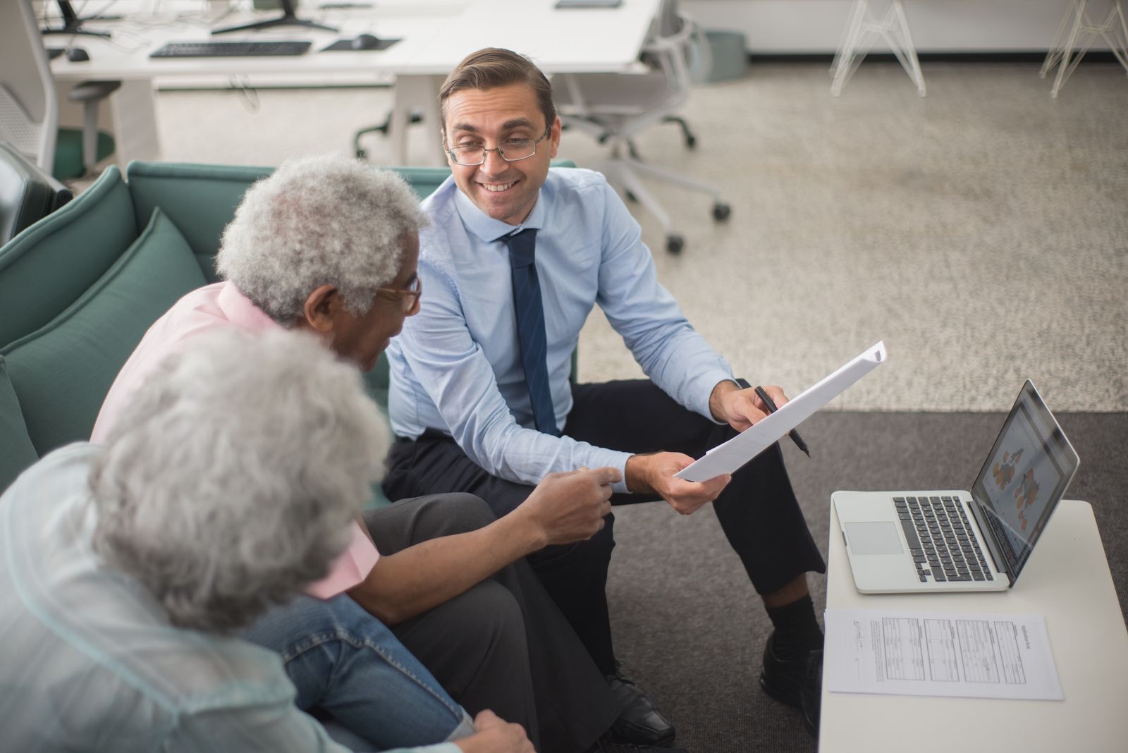 Sunbelt Shield agent reviewing a policy with a couple at her desk